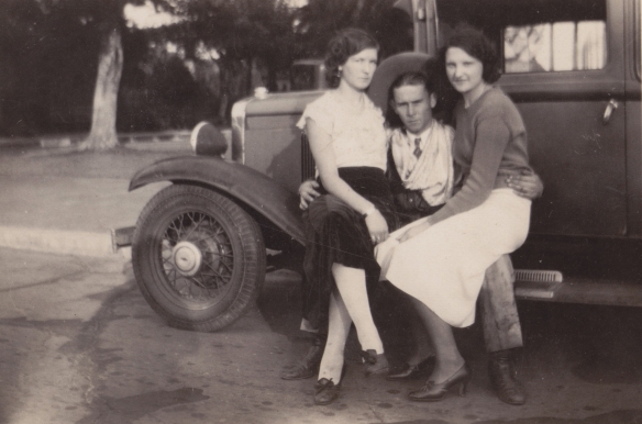 Grandma and two siblings on the running board of the Chevy